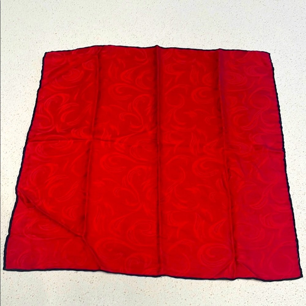 100% Silk pocket square in Red Swirl with Black rolled edges.